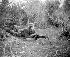 Australian soldier mans machine gun position in Vietnam. Via Wikimedia Commons