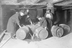 Prohibition agents destroying barrels of alcohol